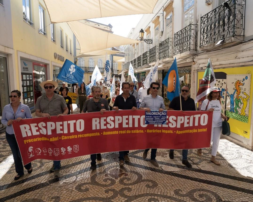 Multidão de trabalhadores e sindicatos em manifestação organizada no 1º de Maio em Faro com bandeiras e cartazes